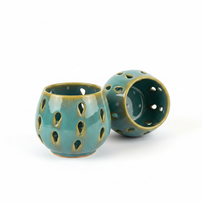 Ceramic tealight holders on white background